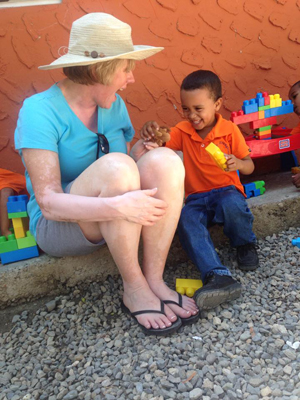 Joan plays blocks with a Project Mañana student