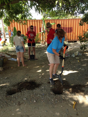 The team installs a new fence for a local family